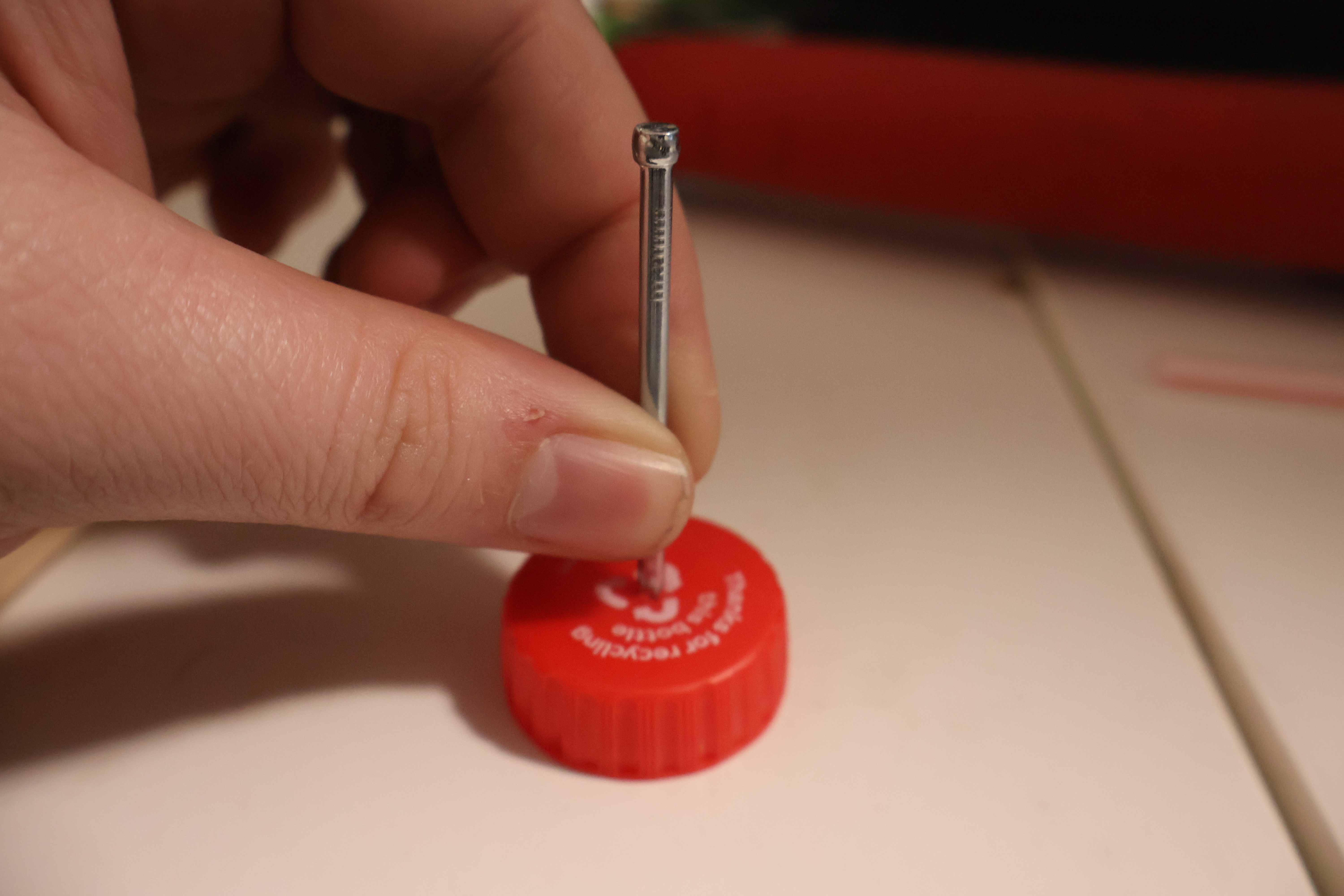 Step 5: Use a hammer and nail to create a small hole